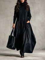 Casual Long Dress Featuring A High-neck Knit Bodice And Woven Skirt Panel.